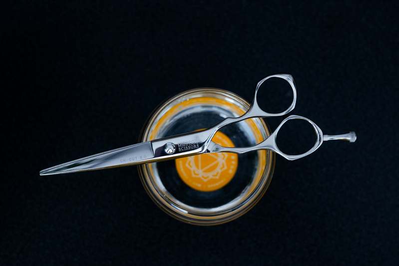 Arrangement of high-quality eyebrow scissors alongside tweezers and brushes on a clean vanity
